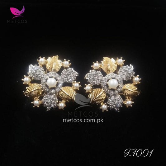 Leaf gold plated studs shown at an angle, showing the diamond-cut edge and earring post