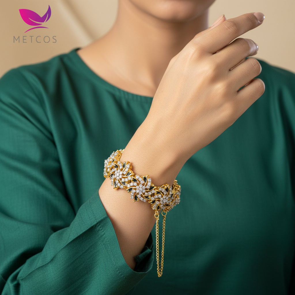 A 24K gold plated, diamond cut, openable clip lock kara styled bracelet featuring real American zircons on a stone inlay design, displayed on a textured background.