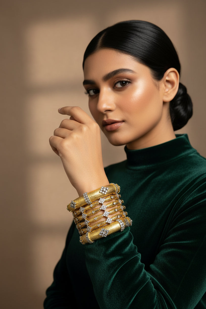 Stack of six 24K gold plated diamond-cut bangles set with American zircon clusters, worn together on one wrist