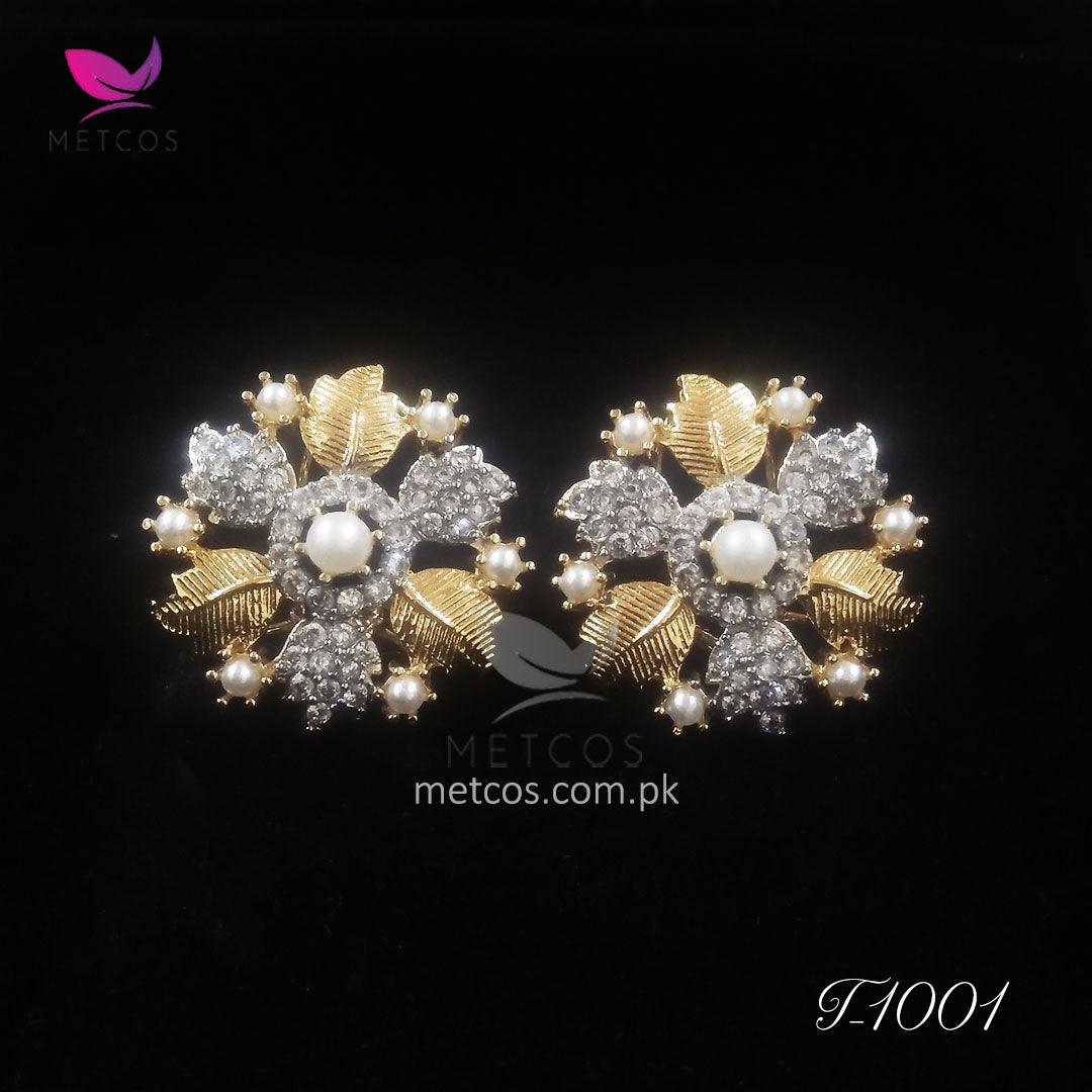 Leaf gold plated studs shown at an angle, showing the diamond-cut edge and earring post