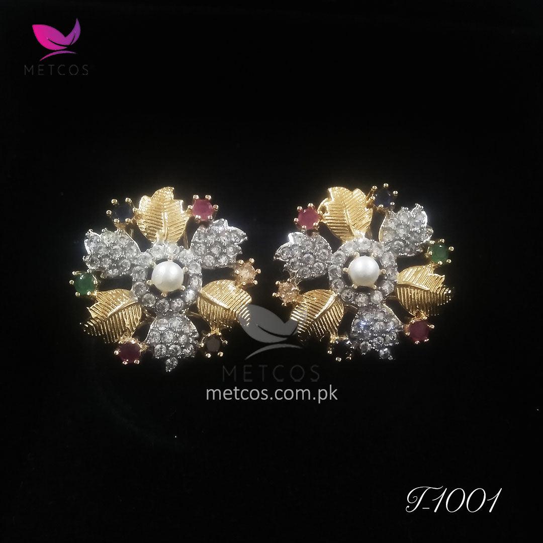 Leaf gold plated studs worn on the ear, showing their size in wear