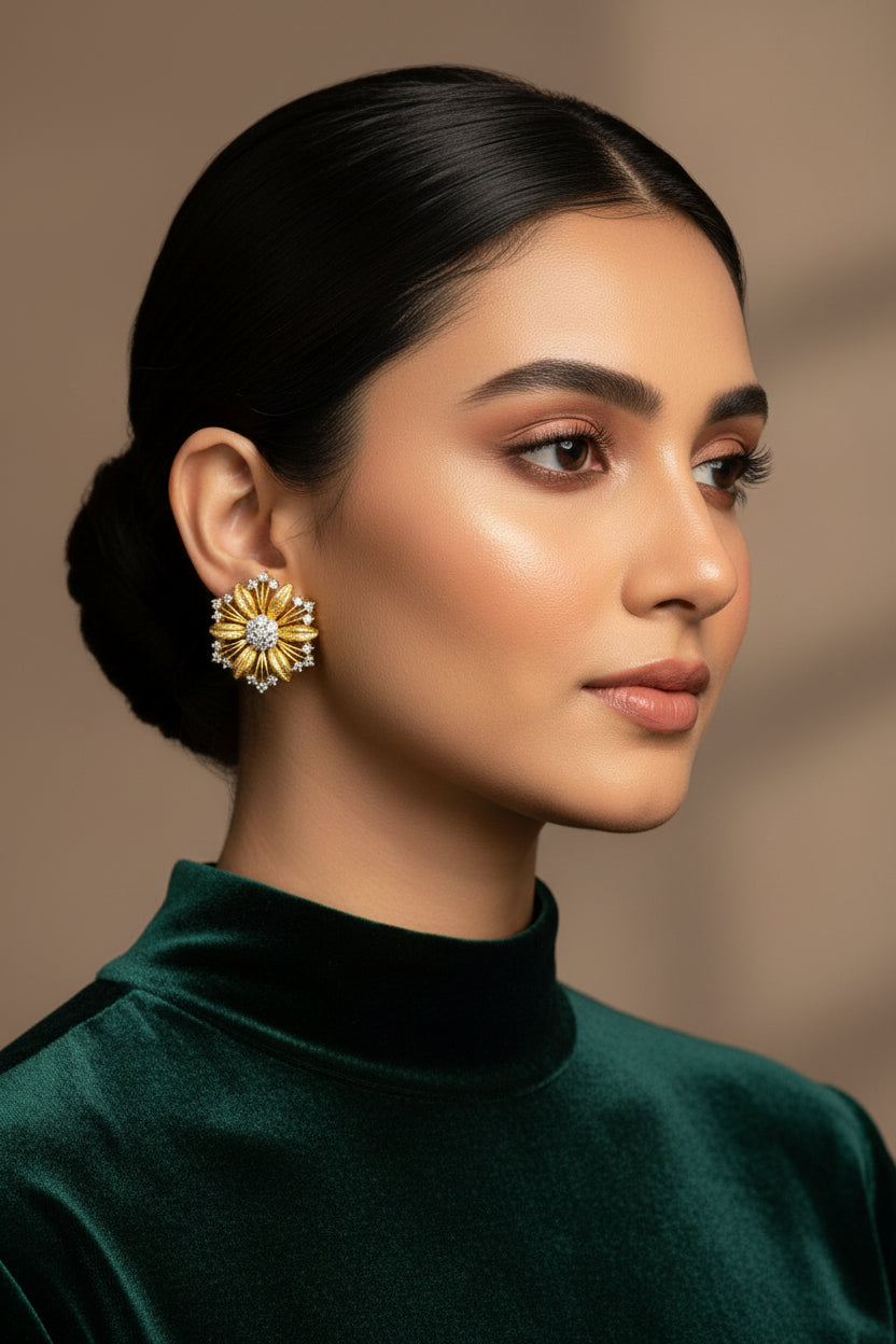 A pair of 24k gold plated tiffany stud earrings with intricate diamond cut patterns and embellished with real American Zircons.