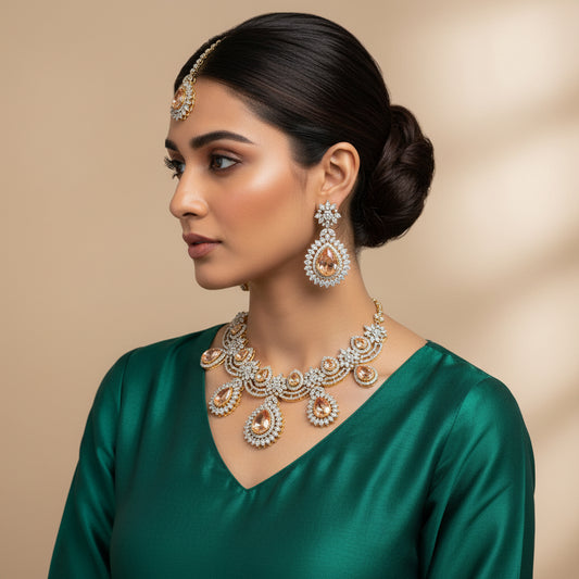 A set of gold-plated jewelry with intricate designs and embellishments, including a necklace and earrings with zircon stones and bindiya.